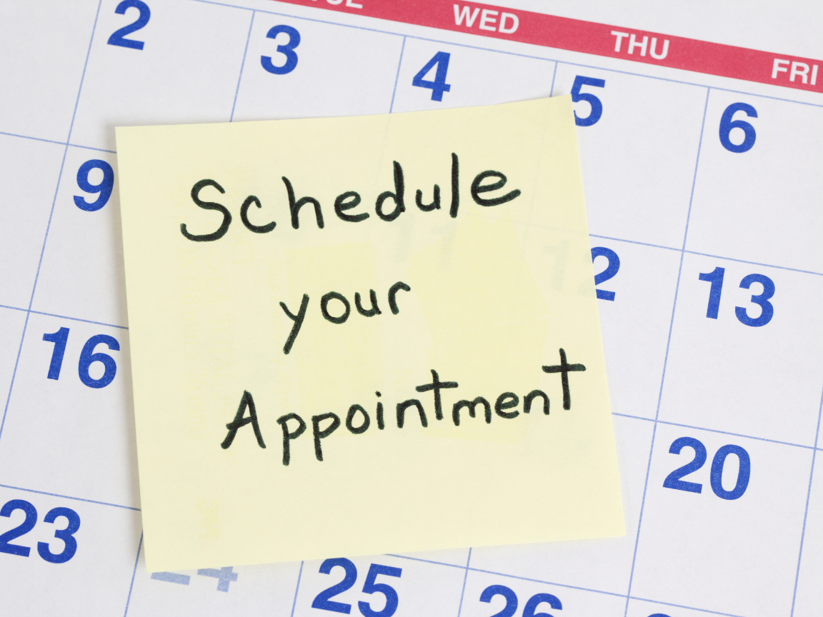 A sticky note on a calendar that reads 